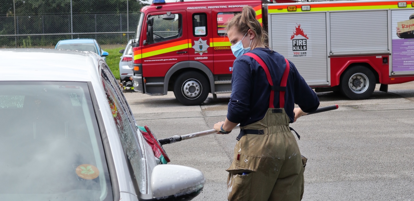 Car wash header firefighter with mask on