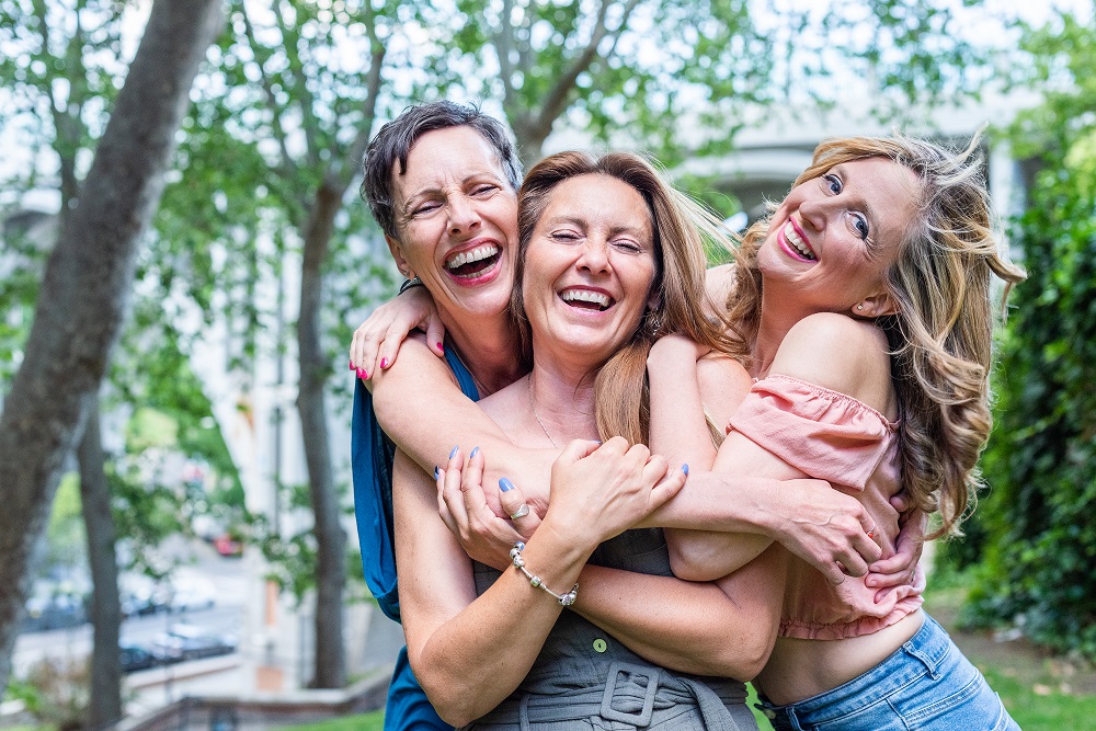 Close,Up,Of,Three,Cheerful,Mature,Female,Friends,Hugging,Together