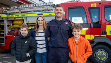 on-call firefighter and family by fire appliance