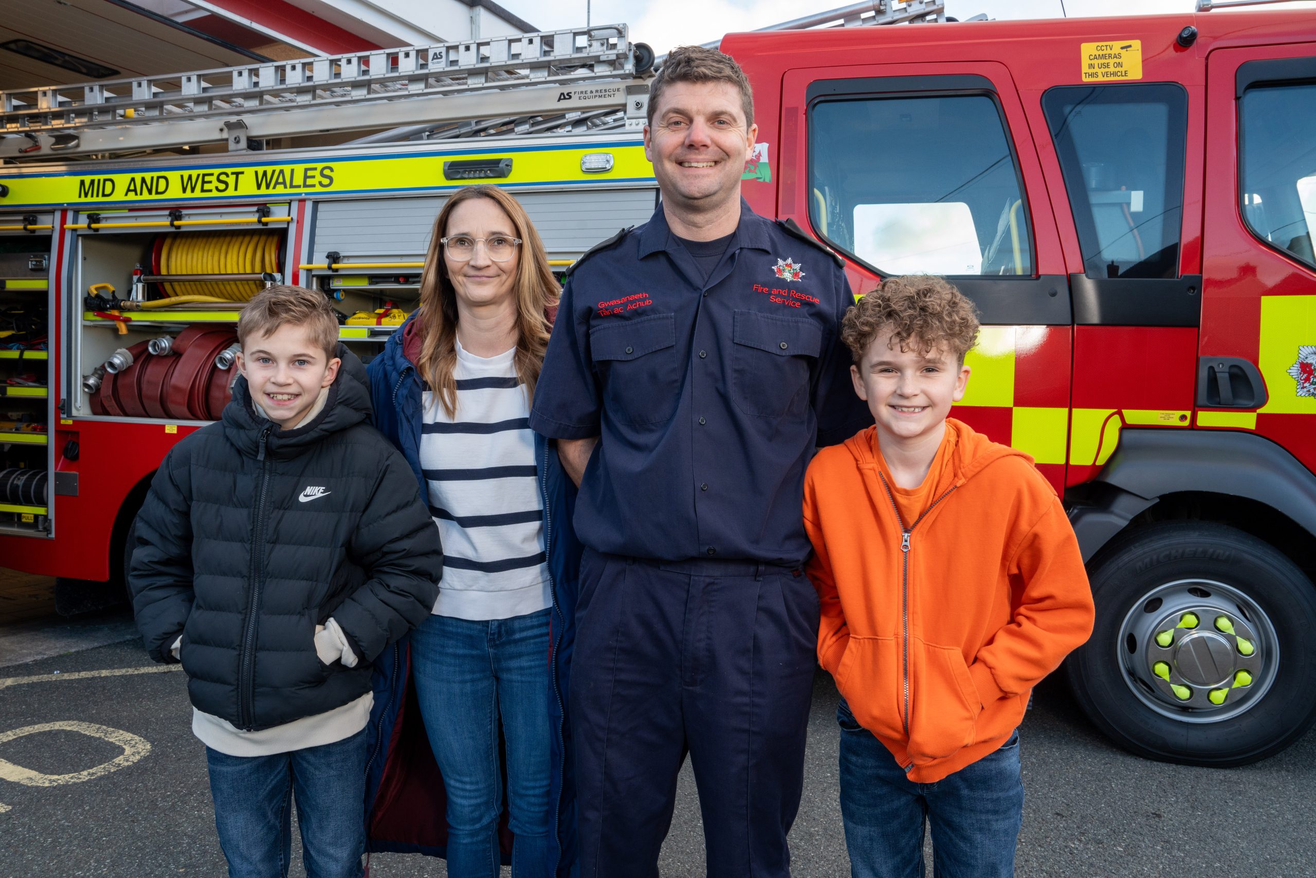 on-call firefighter and family by fire appliance