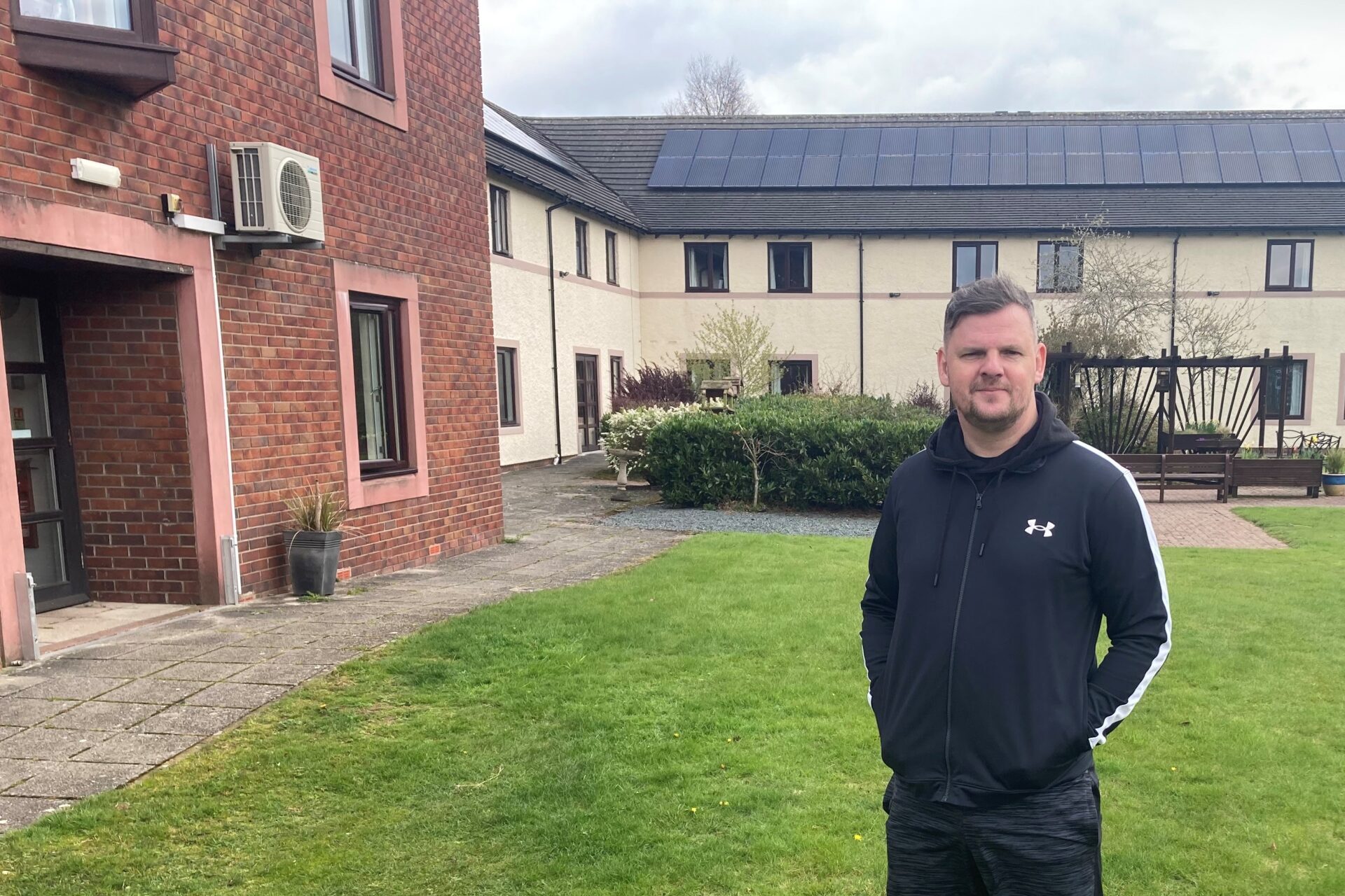 Prison Officer Iain Templeton standing outside Fire Fighters Charity's Jubilee House centre 
