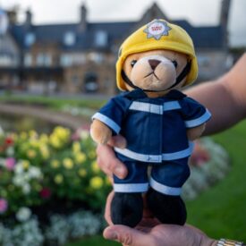 A hand holding a stuffed animal.